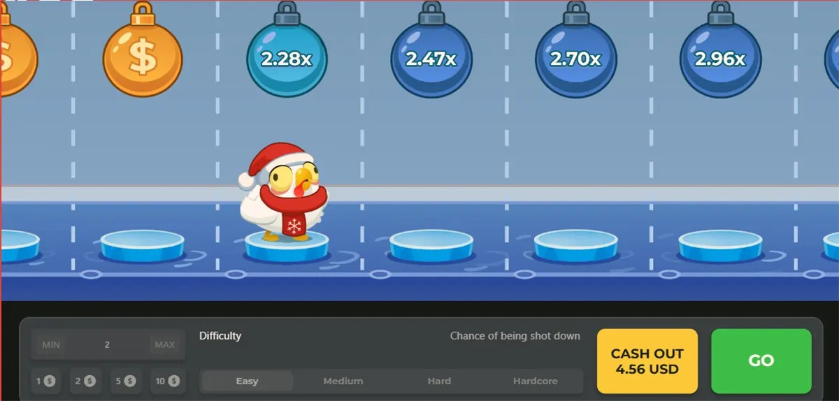 Screenshot of a winter-themed Chicken Road-style game showing a small chicken in a Santa hat on icy stepping stones, with hanging multiplier bombs above (2.28x, 2.47x, 2.70x, 2.96x) and a bottom bar for bet and difficulty settings plus “CASH OUT 4.56 USD” and a green “GO” button.